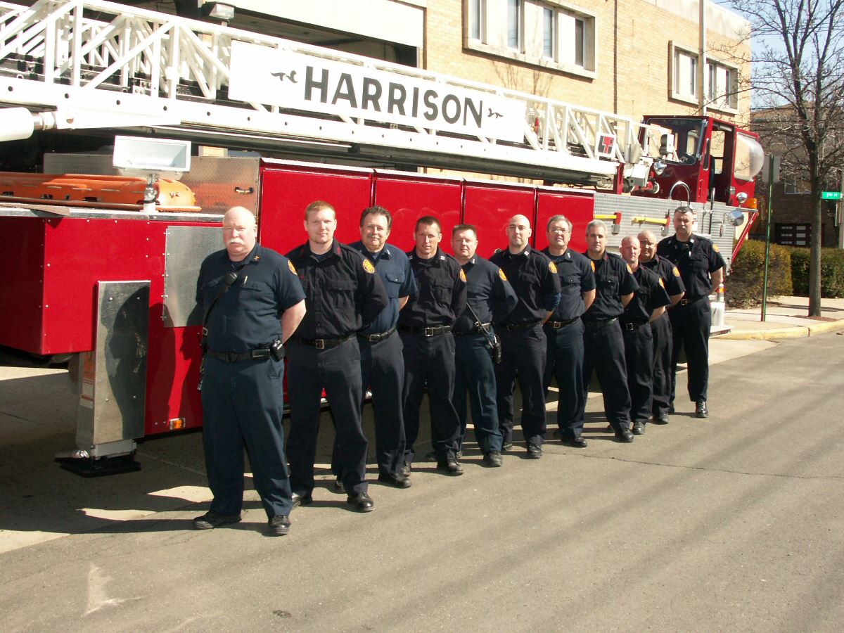 Members of Fire Department Standing Next to Fire Truck